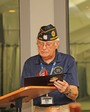 American Legion Post 370 Adjutant, Ken Knight, presents immediate Past Commander Ed McCloskey with a humorous card.